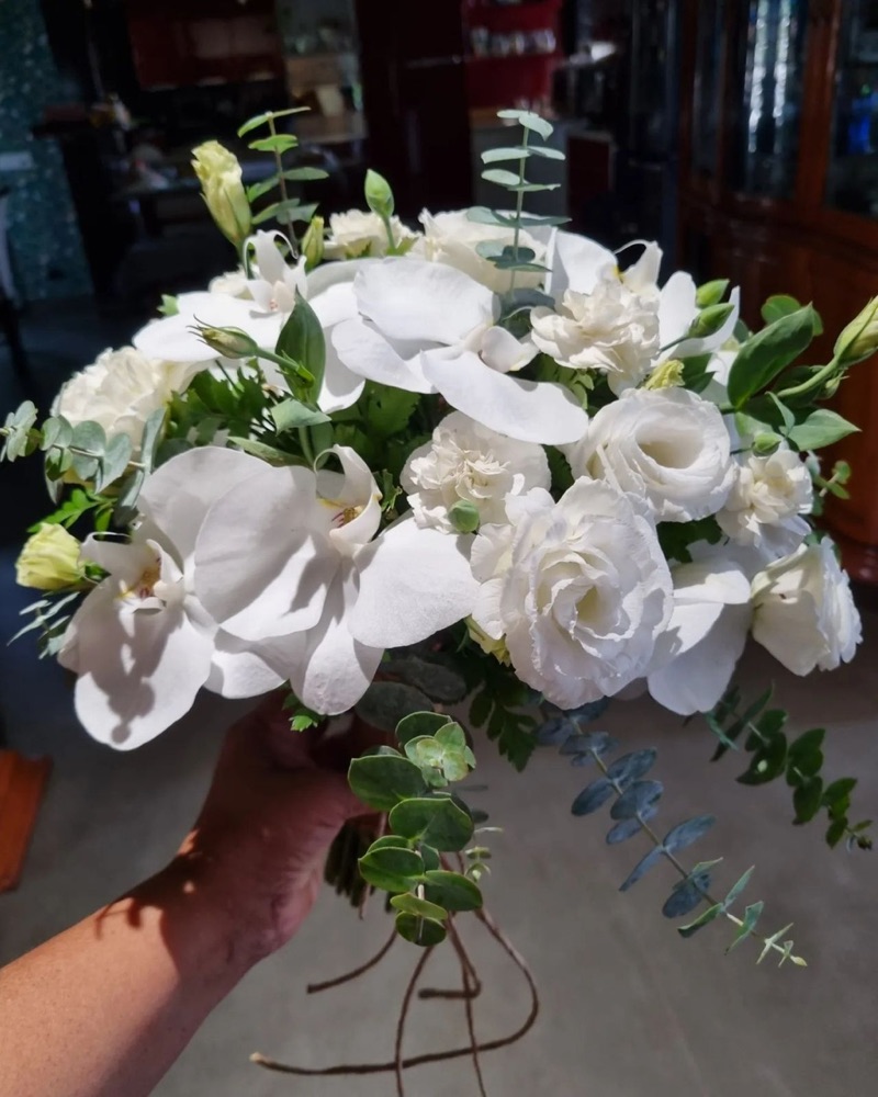 White orchid and lisianthus round bridal bouquet